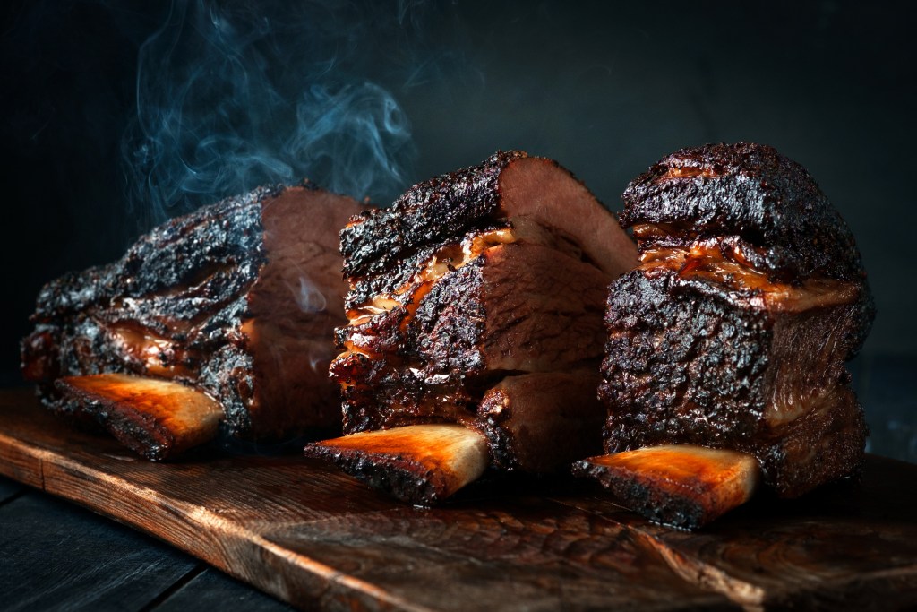 Cut a large piece of smoked beef brisket to the ribs with a dark crust. Classic Texas barbecue
