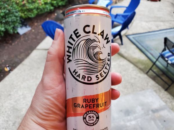 Person's hand holding a container of White Claw brand hard seltzer in an outdoor setting, Lafayette, California, December 8, 2021. Photo courtesy Sftm. (Photo by Gado/Getty Images)