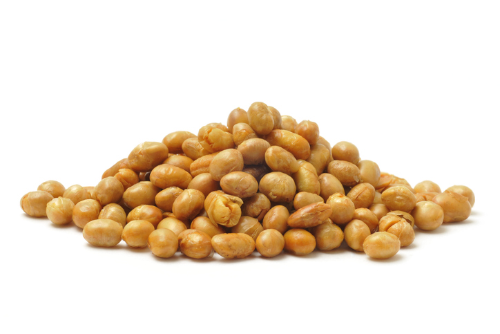 Roasted soya beans in a pile isolated on a white background.