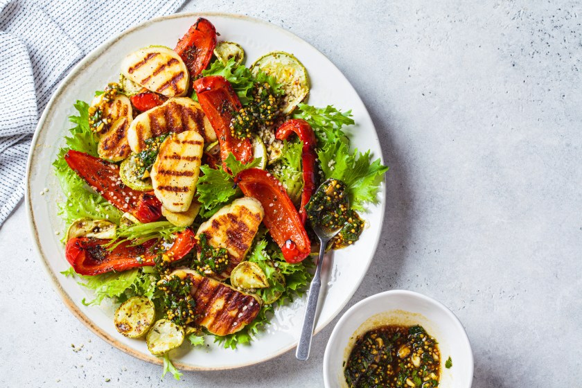 Grilled halloumi salad with baked vegetables and mustard dressing. Comfort food concept.